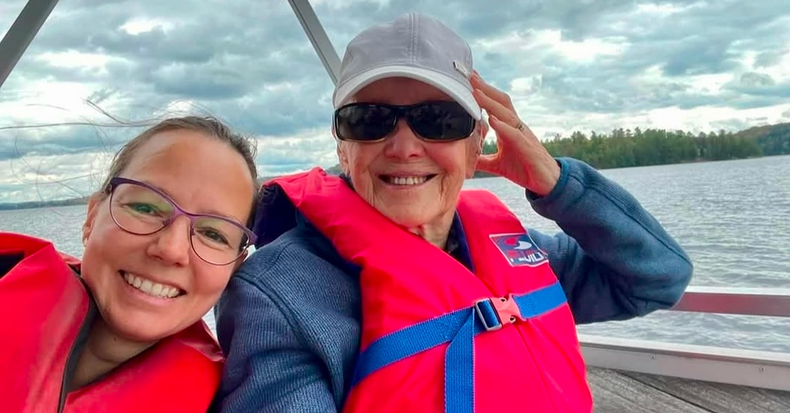 an active senior adult with sunglasses on a boat
